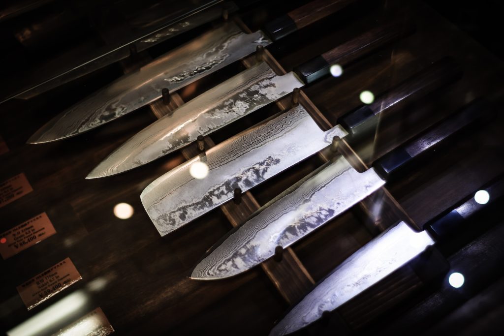 Japanese kitchen knives on a dark magnetic strip